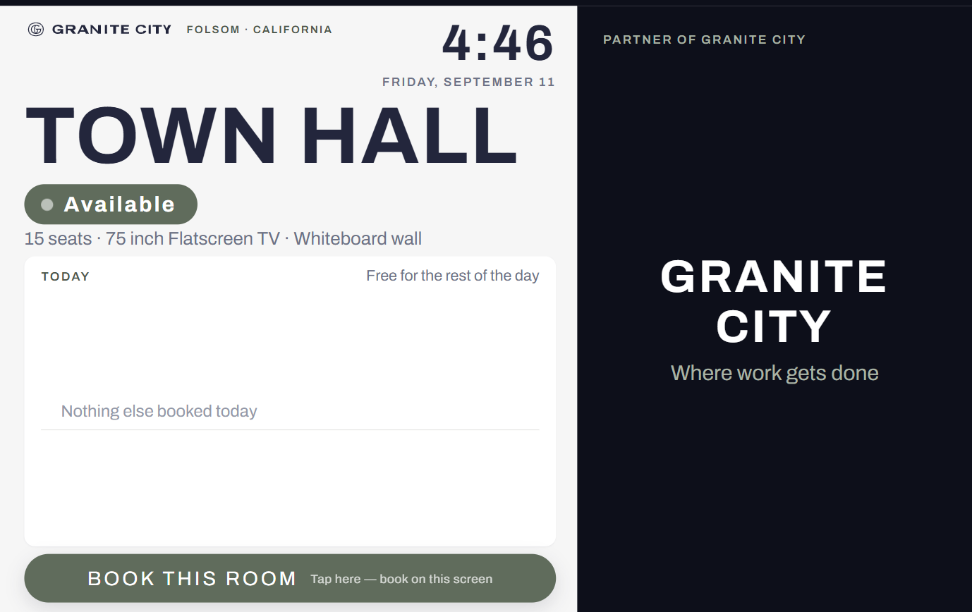 Town Hall room display showing live availability and a partner panel at Granite City Workspaces